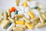 close up of various types of supplement tablets, capsules, and softgels