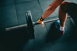 man getting ready to lift a barbell at the gym