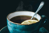black tea with lemon in a blue ceramic mug