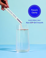 Modern Dose Cognition Boost supplement stick pack being added to a glass of water with a blue background and text about focus & clarity. Black Friday promotion