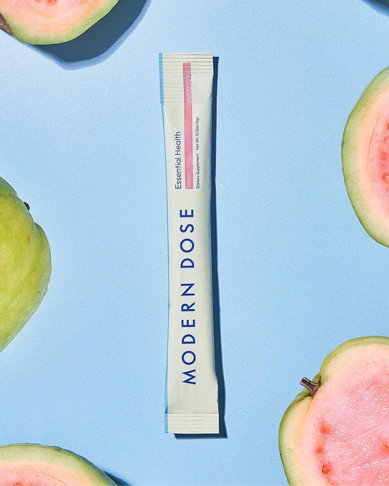 Modern Dose supplement stick pack with guava slices on a blue background - www.moderndose.com