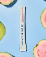 Modern Dose supplement stick pack with guava slices on a blue background - www.moderndose.com