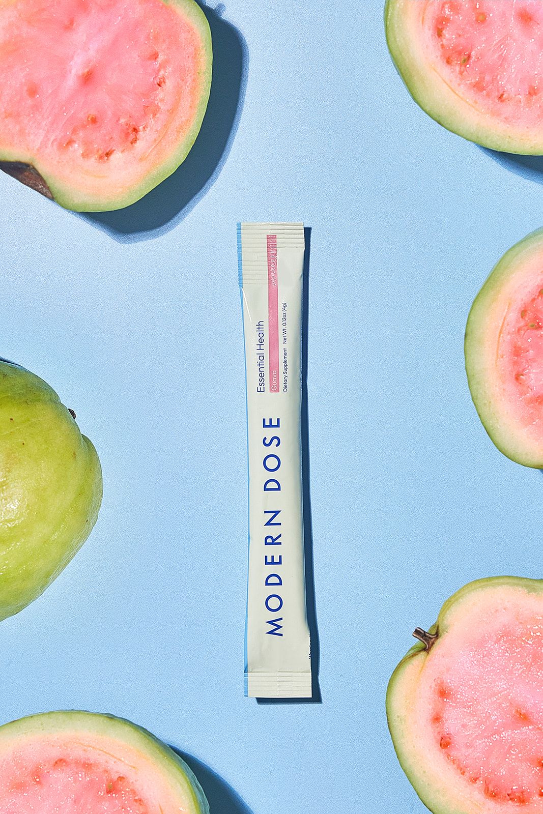Modern Dose Essential Health stick pack with halved guava around it - www.moderndose.com