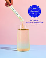 Modern Dose Stress & Mood Balance supplement stick pack product being added to a glass of water with a pink and blue background and text about calm & balanced mood
