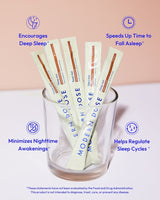 Glass with Modern Dose sleep aid supplement packets on a light pink background - www.moderndose.com
