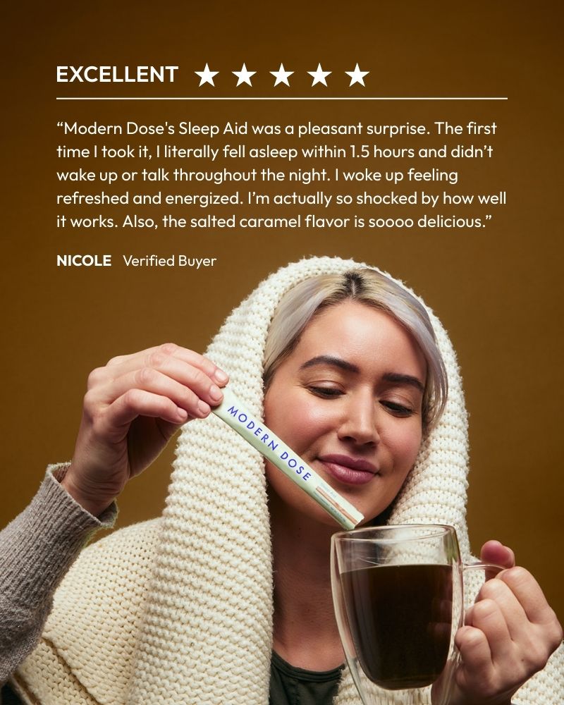 Woman holding a Modern Dose Sleep Aid stick pack and a glass of Sleep Aid with a five-star review text above.